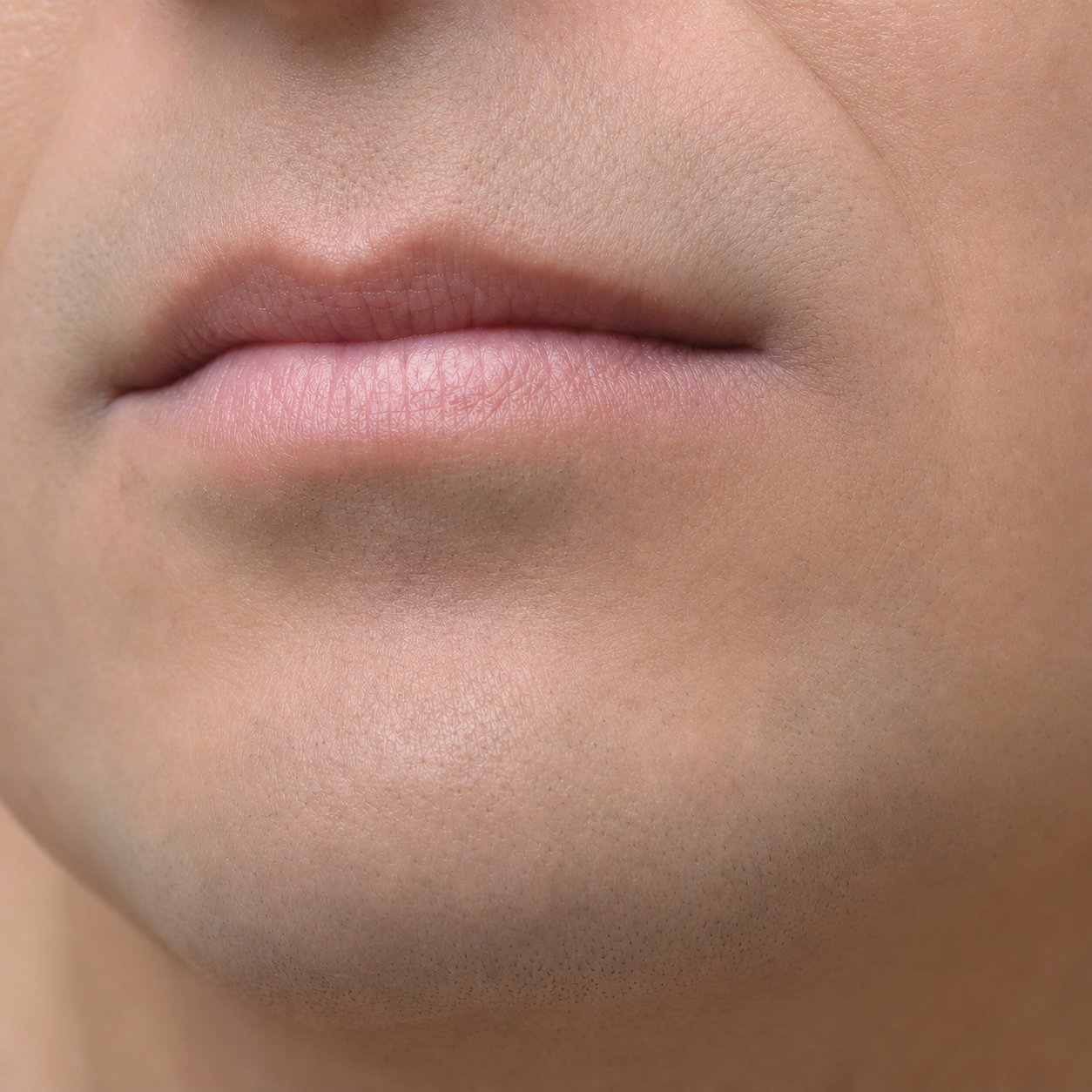 Same clean-shaven man's mouth corner 48 hours later, actively healing on the Labisan Protective Lip Balm protocol with full resolution typically by day 5
